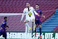 | Photo:AP/Joan Monfort : Mallorca's Vedat Muriqi, front, and Barcelona's Eric Garcia jump for the ball during the Spanish La Liga soccer match between Barcelona and Mallorca in Barcelona, Spain.