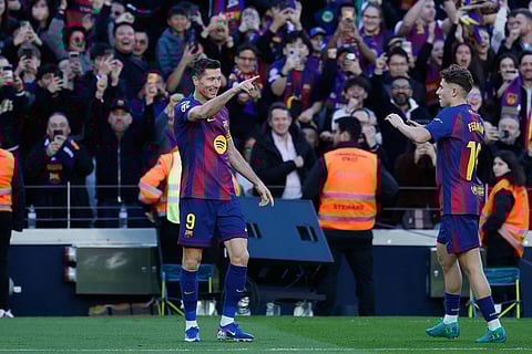 Barcelona's Robert Lewandowski, left, celebrates scoring his side's opening goal during the Spanish La Liga soccer match between Barcelona and Mallorca in Barcelona, Spain.
