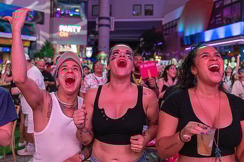 Fans in San Juan, Puerto Rico, watch Bad Bunny's performance on television during the halftime show of the NFL Super Bowl 60 football game.