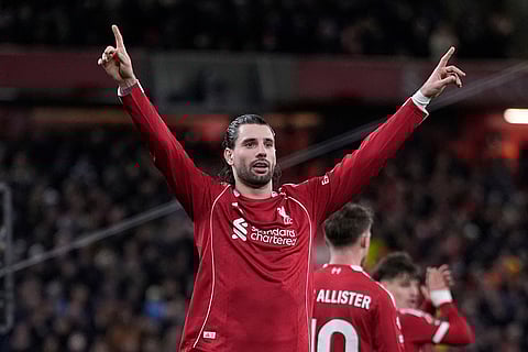 Liverpool's Dominik Szoboszlai celebrates scoring during the English Premier League soccer match between Liverpool and Manchester City in Liverpool, England.