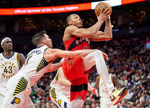 Toronto Raptors forward Scottie Barnes, right, is fouled by Indiana Pacers guard T.J. McConnell, front left, during second-half NBA basketball game action in Toronto.