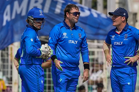 Italy's JJ Smuts, center, celebrates with teammates the wicket of Scotland's Michael Jones during the T20 World Cup cricket match between Italy and Scotland in Kolkata.