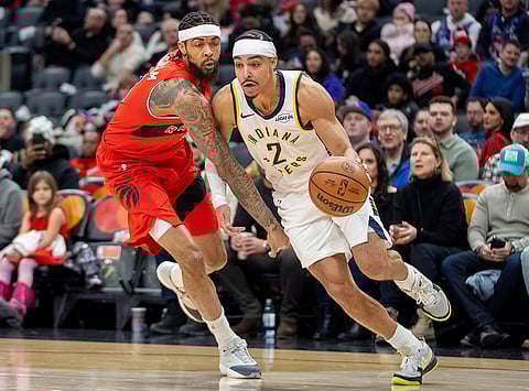 Indiana Pacers guard Andrew Nembhard (2) drives past Toronto forward Raptors Brandon Ingram, left, during first-half NBA basketball game action in Toronto.