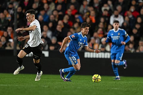 Real Madrid's Arda Guler, centre, and Valencia's Pepelu, left, challenge for the ball during the Spanish La Liga soccer match between Valencia and Real Madrid in Valencia, Spain.