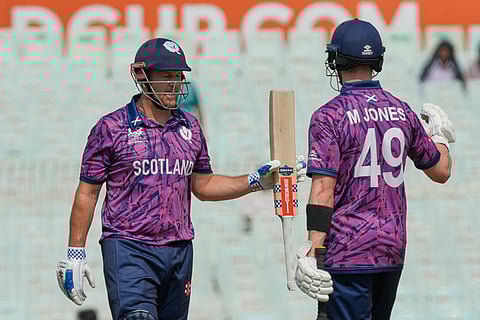 Scotland's George Munsey celebrates his fifty runs with batting partner Michael Jones during the T20 World Cup cricket match between Italy and Scotland in Kolkata.