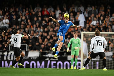 Real Madrid's Dean Huijsen heads the ball during the Spanish La Liga soccer match between Valencia and Real Madrid in Valencia, Spain.