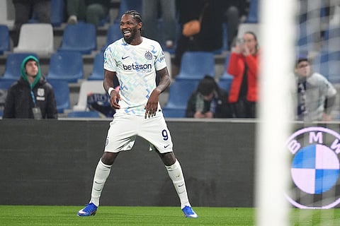 Inter Milan's Marcus Thuram celebrates after scoring their side's second goal of the game during the Serie A soccer match between Sassuolo and Inter in Milan, Italy.