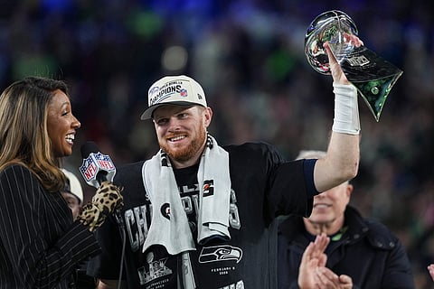 Seattle Seahawks quarterback Sam Darnold lifts the Lombardi Trophy after a win over the New England Patriots in the NFL Super Bowl 60 football game in Santa Clara, California.