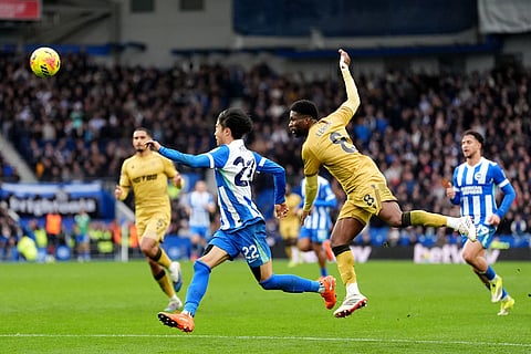 Brighton and Hove Albion's Kaoru Mitoma, left, battle for the ball with Crystal Palace's Jefferson Lerma during their English Premier League soccer match in Brighton, England.
