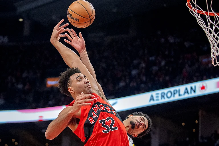 Toronto Raptors forward Trayce Jackson-Davis (32) is fouled by Indiana Pacers guard Ben Sheppard, right, as he goes in for a dunk during second-half NBA basketball game action in Toronto. - | Photo: Frank Gunn/The Canadian Press via AP