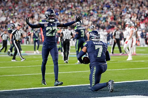 Seattle Seahawks linebacker Uchenna Nwosu (7) celebrates his touchdown on a fumble recovery with cornerback Riq Woolen (27) runs during the second half of the NFL Super Bowl 60 football game in Santa Clara, California.
