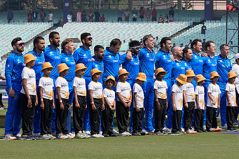 Italy players stand for the national anthems of the respective countries before the start of the T20 World Cup cricket match between them in Kolkata.