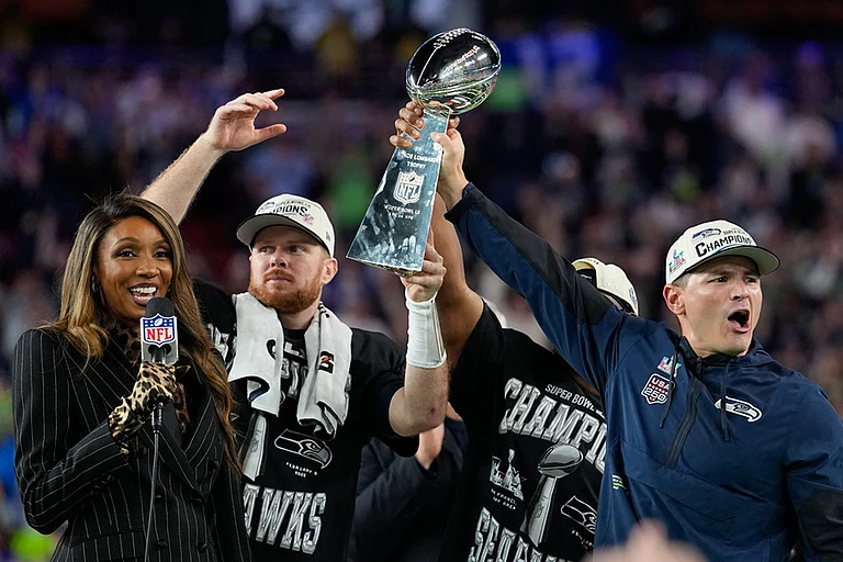 Seattle Seahawks head coach Mike MacDonald, right, and quarterback Sam Darnold lift the Lombardi Trophy after win over the New England Patriots in the NFL Super Bowl 60 football game in Santa Clara, California. - | Photo: AP/Julio Cortez