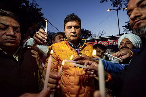 In this image posted on Feb. 8, 2026, AAP's Delhi unit chief Saurabh Bharadwaj light candles with others in tribute to a biker who died after falling fell into a 15-feet deep pit dug by the Delhi Jal Board, at Janakpuri area, in New Delhi. Kamal Dhyani, an employee of a private bank in Rohini's Sector 10, was returning home on the intervening night of Thursday and Friday when he fell into a pit dug by the DJB for a sewer pipeline restoration project.