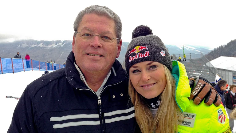 United States' Lindsey Vonn, right, poses for photographs with her father Alan Kildow at the end of an alpine ski, women's World Cup downhill race, in Cortina d'Ampezzo, Italy, Friday, Jan. 16, 2015. - (AP Photo/Andrew Dampf, File)