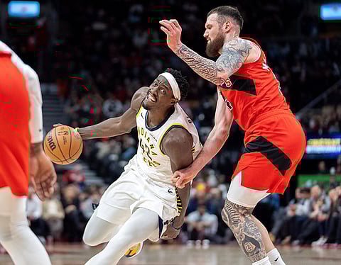 Indiana Pacers forward Pascal Siakam, left, drives past Toronto Raptors forward Sandro Mamukalashvili, right, during first-half NBA basketball game action in Toronto.
