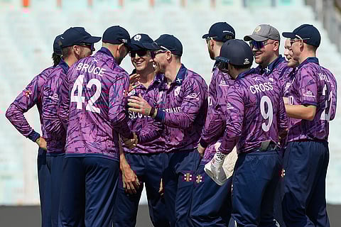 Scotland players celebrate the wicket of Italy's Justin Mosca during the T20 World Cup cricket match between Italy and Scotland in Kolkata.