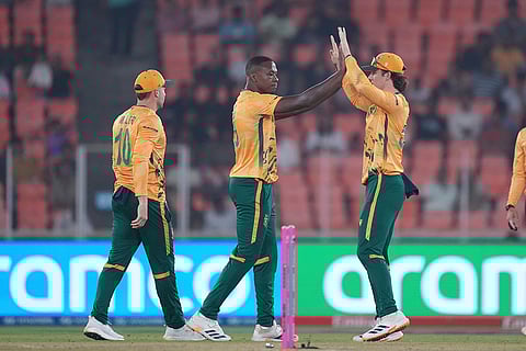 South Africa's Kagiso Rabada, centre, celebrates the wicket of Canada's Shreyas Movva during the T20 World Cup cricket match between Canada and South Africa in Ahmedabad.