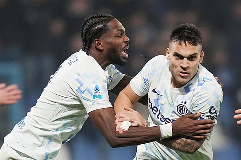 Inter Milan's Lautaro Martinez, right, celebrates with teammate Marcus Thuram after scoring their side's third goal of the game during the Serie A soccer match between Sassuolo and Inter in Milan, Italy.