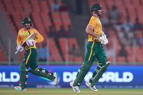 South Africa's captain Aiden Markram, right, and South Africa's Quinton de Kock run between the wickets to score a run during the T20 World Cup cricket match between Canada and South Africa in Ahmedabad.