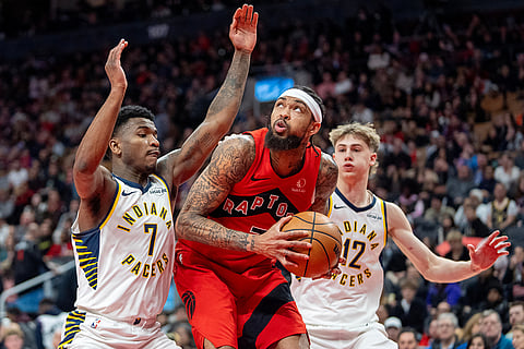 Toronto Raptors forward Brandon Ingram, center, works his way to the hoop past Indiana Pacers guard Kam Jones (7) and Johnny Furphy (12) during second-half NBA basketball game action in Toronto.