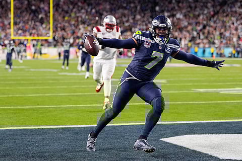 Seattle Seahawks linebacker Uchenna Nwosu (7) celebrates his touchdown on a fumble recovery during the second half of the NFL Super Bowl 60 football game against the New England Patriots in Santa Clara, California.