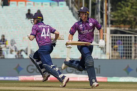 Scotland's captain Richie Berrington and Brandon McMullen run between the wickets to score during the T20 World Cup cricket match between Italy and Scotland in Kolkata.