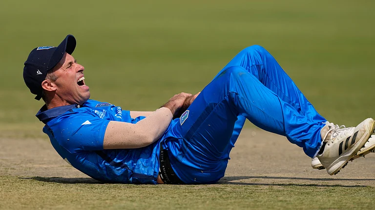 Italy's captain Wayne Madsen reacts after a miss-fielding by him which hurt his hand during the T20 World Cup cricket match between Italy and Scotland in Kolkata, India, Monday, Feb. 9, 2026 - (AP Photo/Bikas Das)