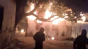 Video screen grab from X : Video footage circulating online shows armed men setting houses and vehicles alight in the village, with militants in camouflage firing sophisticated weapons into the air.