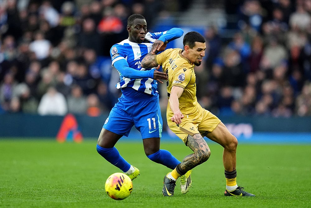 Brighton and Hove Albion's Yankuba Minteh, left, and Crystal Palace's Daniel Munoz in action during their English Premier League soccer match in Brighton, England. - | Photo: Adam Davy/PA via AP