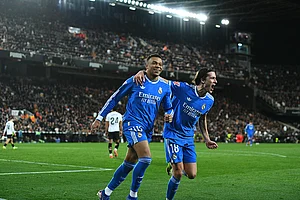 | Photo: AP/Francisco Macia : Real Madrid's Kylian Mbappe, left, celebrates with Alvaro Carreras after scoring his side's second goal during the Spanish La Liga soccer match between Valencia and Real Madrid in Valencia, Spain.