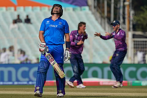 Italy's Benjamin Manenti leaves the ground after losing his wicket during the T20 World Cup cricket match between Italy and Scotland in Kolkata.