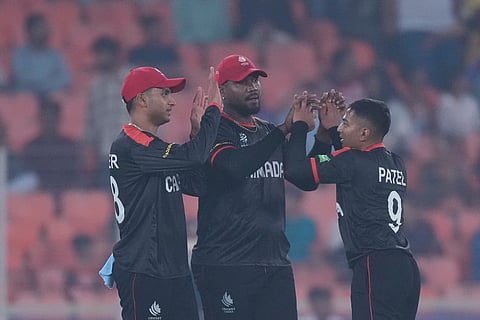 Canada's Ansh Patel, right, celebrates with teammates the wicket of South Africa's captain Aiden Markram during the T20 World Cup cricket match between Canada and South Africa in Ahmedabad.