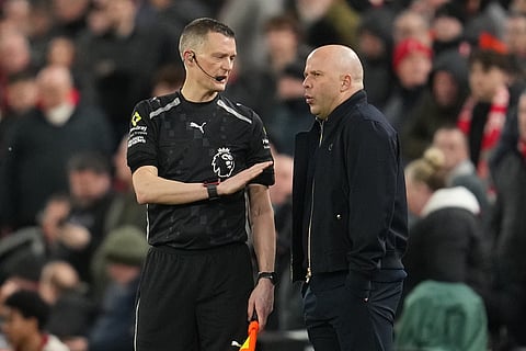 Liverpool's manager Arne Slot talks to a referee during the English Premier League soccer match between Liverpool and Manchester City in Liverpool, England.