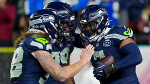 | Photo: AP/Brynn Anderson : Seattle Seahawks linebacker Uchenna Nwosu, right, is congratulated by teammates after recovering a fumble and returning it for a touchdown during the second half of the NFL Super Bowl 60 football game against the New England Patriots, Sunday, Feb. 8, 2026, in Santa Clara, Calif.