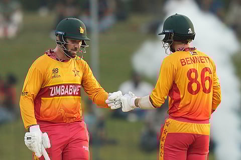 Zimbabwe's Brendan Taylor, left, Brian Bennett encourage each other as they bat during the T20 World Cup cricket match between Oman and Zimbabwe in Colombo, Sri Lanka.