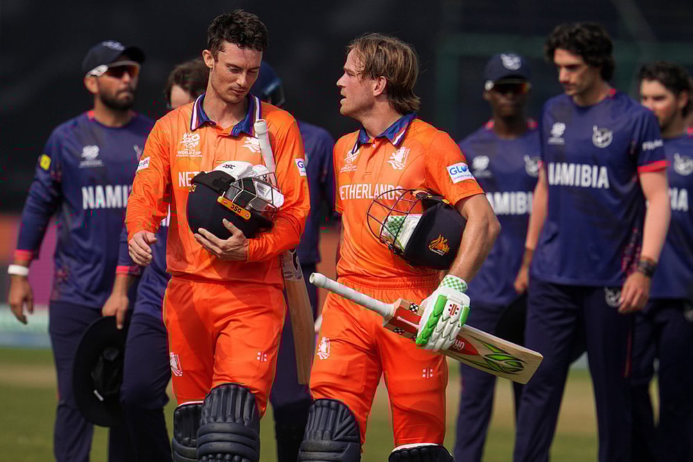 Netherlands' captain Scott Edwards, left and Netherlands' Bas de Leede walks out of the field after their win over Namibia during the T20 World Cup cricket match between Namibia and Netherlands in New Delhi. - | Photo: AP/Manish Swarup