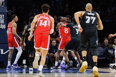Los Angeles Clippers guard Kris Dunn (8) gets in a fight with fMinnesota Timberwolves forward Julius Randle during the second half of an NBA basketball game in Minneapolis.