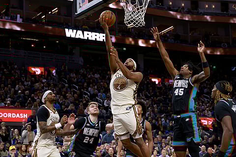 Golden State Warriors guard Moses Moody (4) shoots against Memphis Grizzlies forward GG Jackson (45) during the second half of an NBA basketball game in San Francisco.