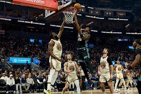 Memphis Grizzlies forward Taylor Hendricks (22) shoots against Golden State Warriors forward Draymond Green (23) during the first half of an NBA basketball game in San Francisco.