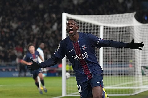 PSG's Ousmane Dembele celebrates after scoring his side's second goal during the French League One soccer match between Paris Saint-Germain and Marseille in Paris.