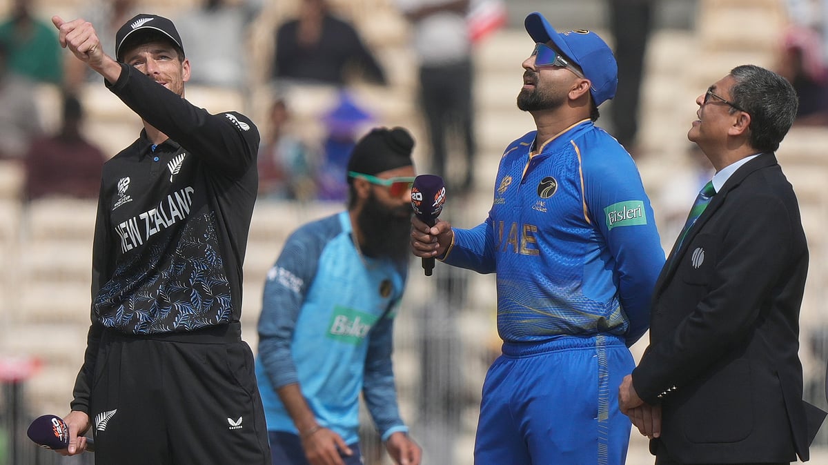 New Zealand's captain Mitchel Santner, left, toss a coin as United Arab Emirates' captain Muhammad Waseem. - AP/Mahesh Kumar A.