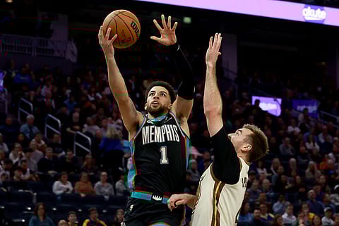 Memphis Grizzlies guard Scotty Pippen Jr. (1) shoots against Golden State Warriors guard Pat Spencer, right, during the first half of an NBA basketball game in San Francisco.