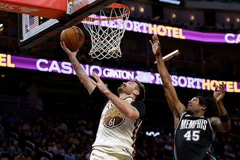 Golden State Warriors guard Pat Spencer (61) shoots agaisnt Memphis Grizzlies forward GG Jackson (45) during the second half of an NBA basketball game in San Francisco.