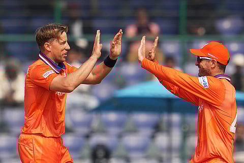 Netherlands' Logan van Beek, left, celebrate the wicket of Namibia's Jan Frylinck during the T20 World Cup cricket match between Namibia and Netherlands in New Delhi.