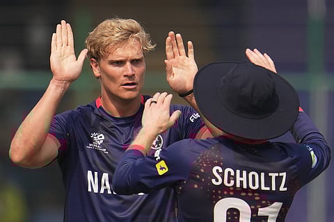 Namibia's Ruben Trumpelmann, left celebrates the dismissal of Netherlands' Michael Levitt during the T20 World Cup cricket match between Namibia and Netherlands in New Delhi.