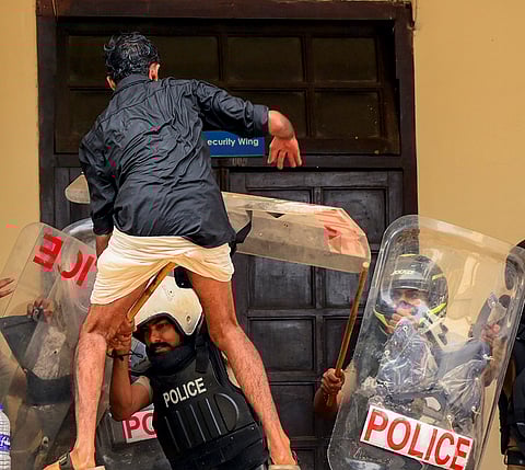 Police personnel attempt to restrain an SFI activist who tried to barge into the room of the Kerala University Registrar during a protest against the University Vice Chancellor over alleged diversion of funds for the conduct of the University Youth Festival, in Thiruvananthapuram.