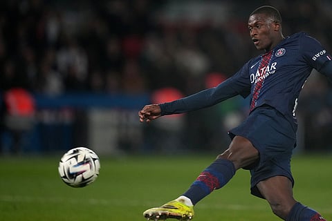 PSG's Nuno Mendes kicks the ball during the French League One soccer match between Paris Saint-Germain and Marseille in Paris.