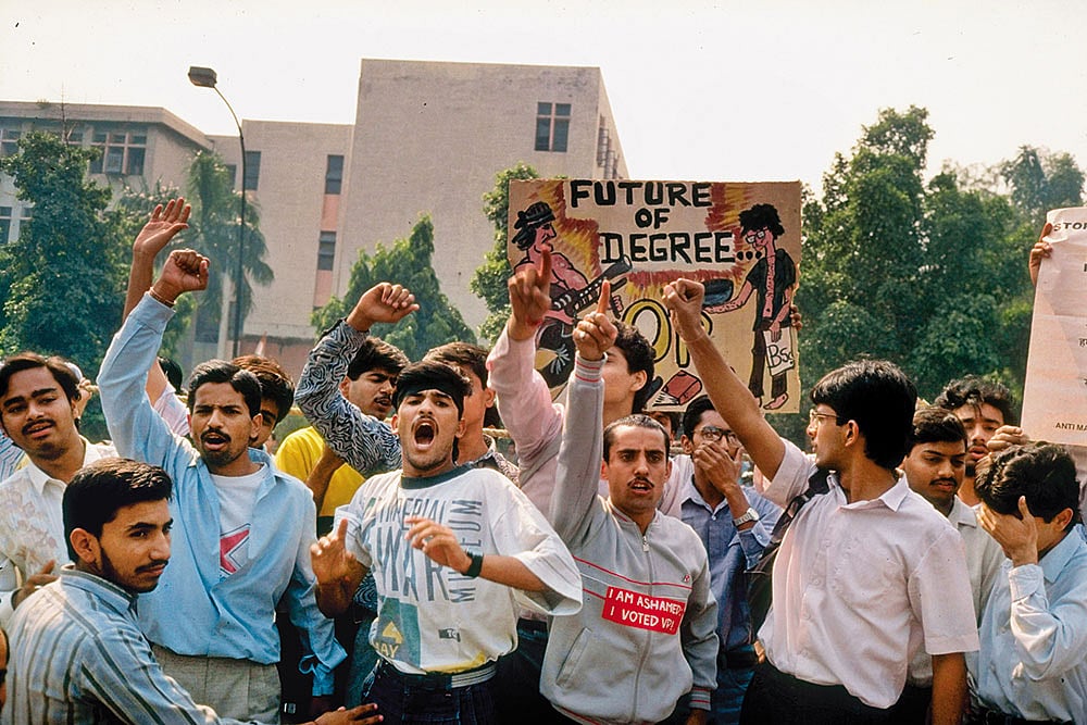 Past Protest: Students protesting in 1990 against the recommendations of the Mandal Commission for quotas in government jobs for backward castes with signs including anti-PM V. P. Singh - null