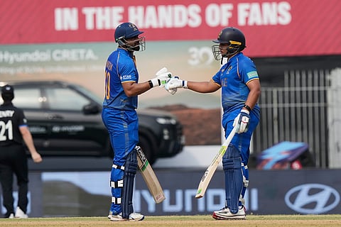 United Arab Emirates' captain Muhammad Waseem, left, and Alishan Sharafu greets each other during the T20 World Cup cricket match between New Zealand and United Arab Emirates in Chennai, India.